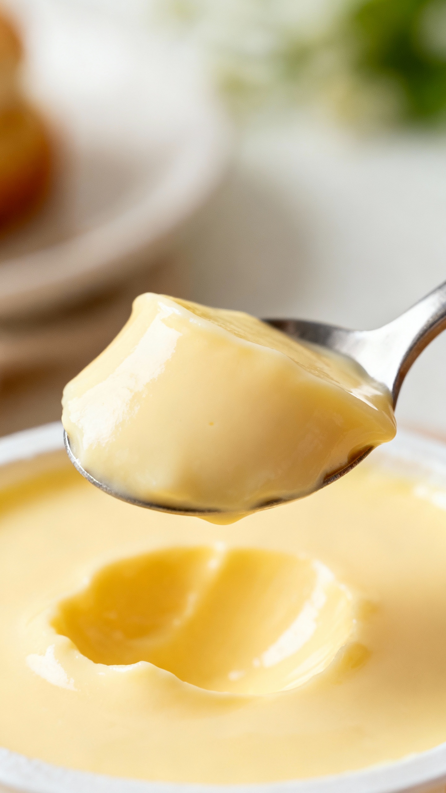 spoonful of silky vanilla pudding, shallow depth