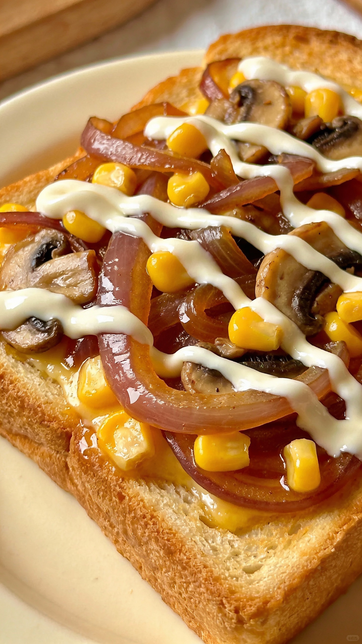 golden toast with onions, corn, mushrooms, white sauce drizzle
