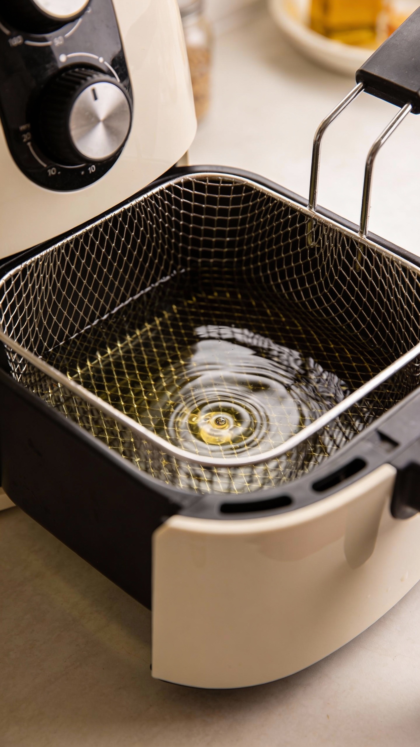 Air fryer basket soaking in vinegar solution, countertop close-up