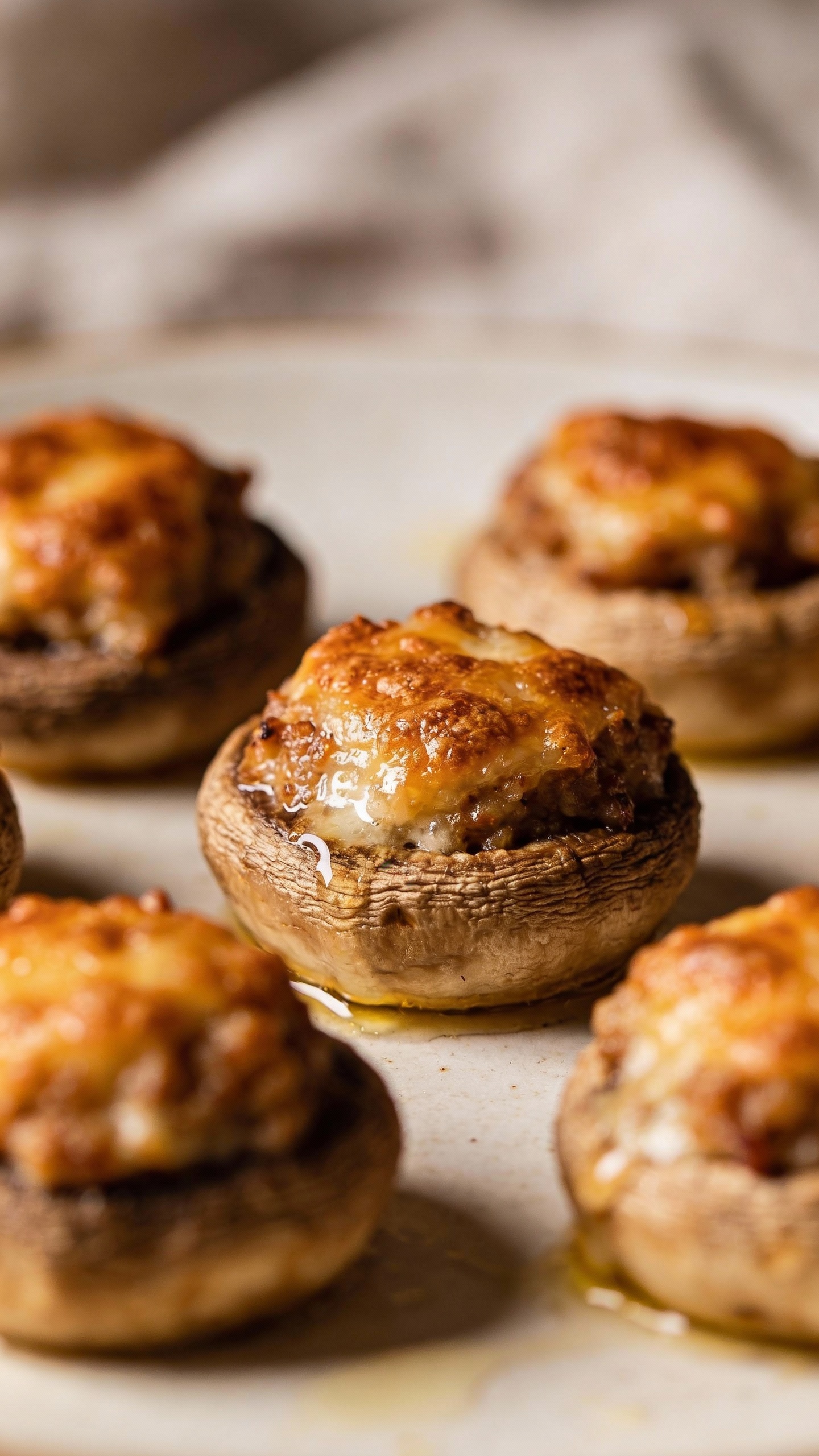 Juicy stuffed mushrooms close-up, golden tops, minimal oil