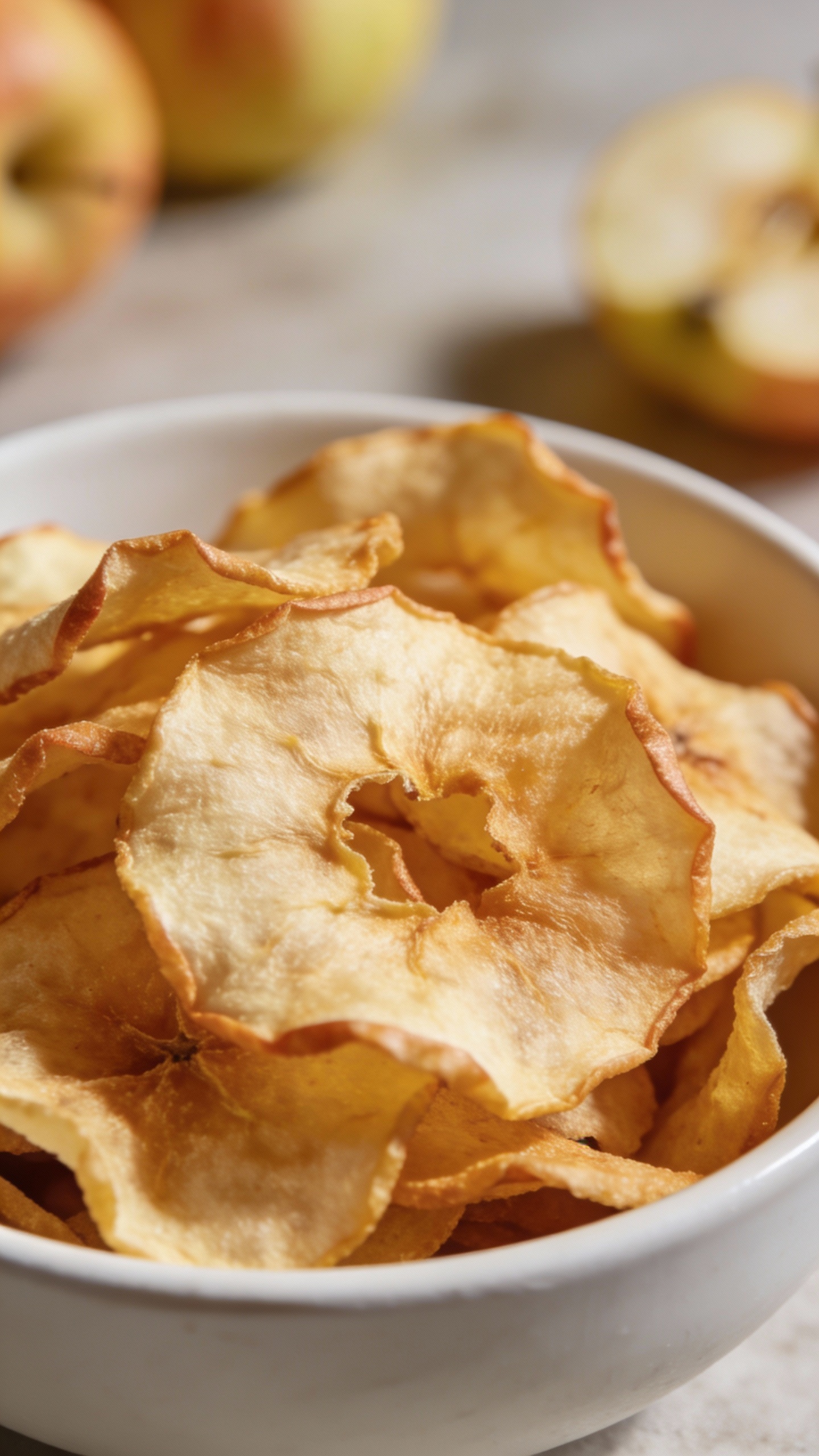 crispy apple chips in white bowl, natural light