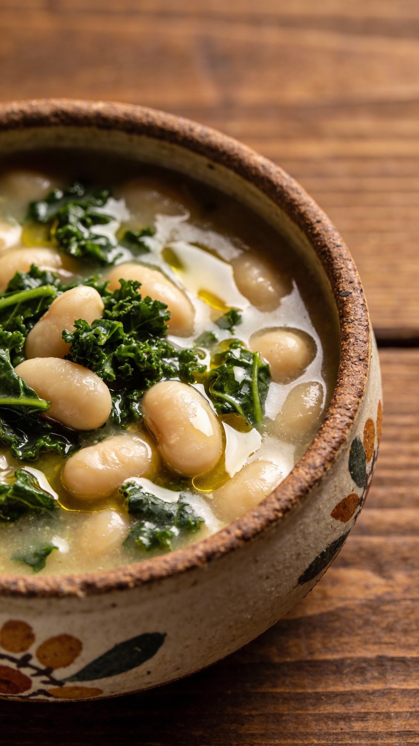 White bean and kale soup in rustic ceramic bowl