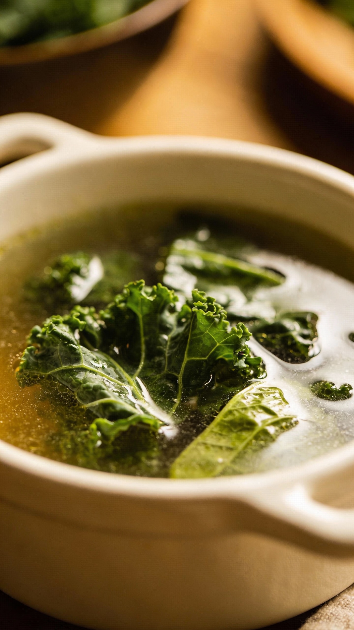 mineral-rich broth with kale and collards in white ceramic bowl