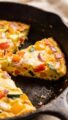 low-cheese vegetable frittata slice on cast-iron skillet