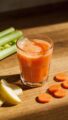 Carrot apple celery juice in clear glass, natural light