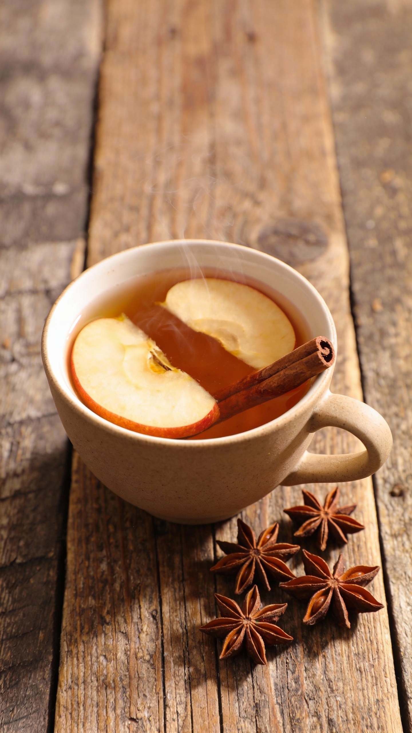 apple cinnamon tea flatlay on rustic wood, star anise