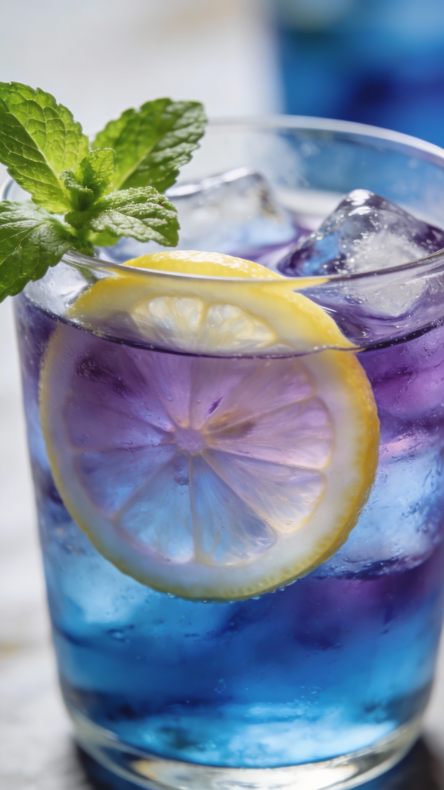 iced blueberry herbal tea with lemon slice and mint sprig