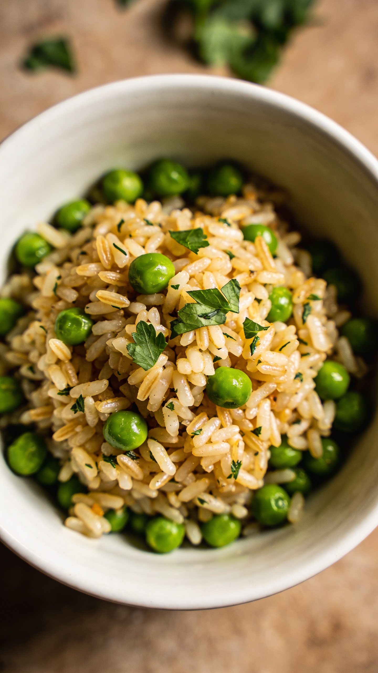 herbed rice and peas in white bowl, overhead