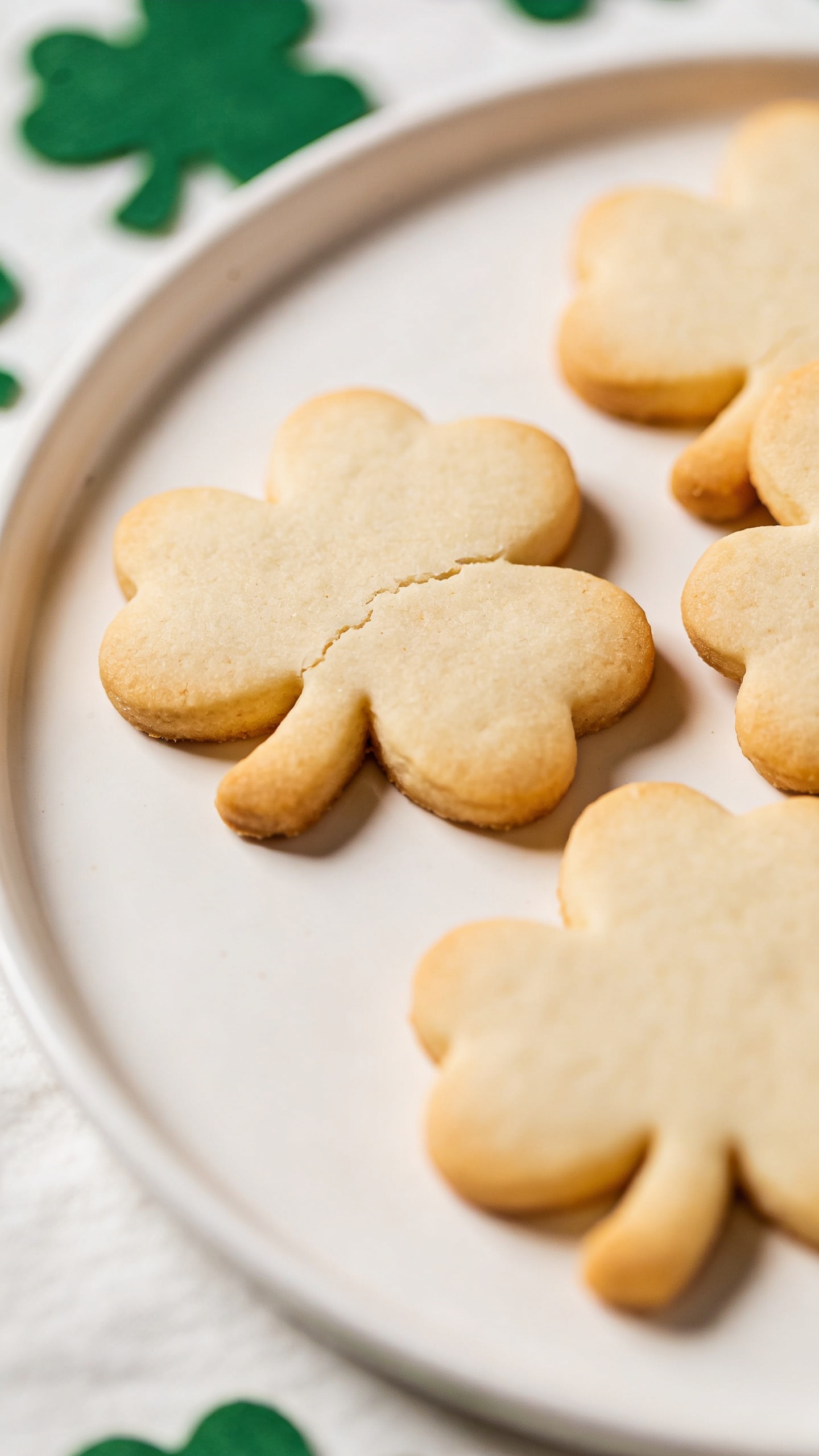shamrock sugar cookies on white plate, soft natural light
