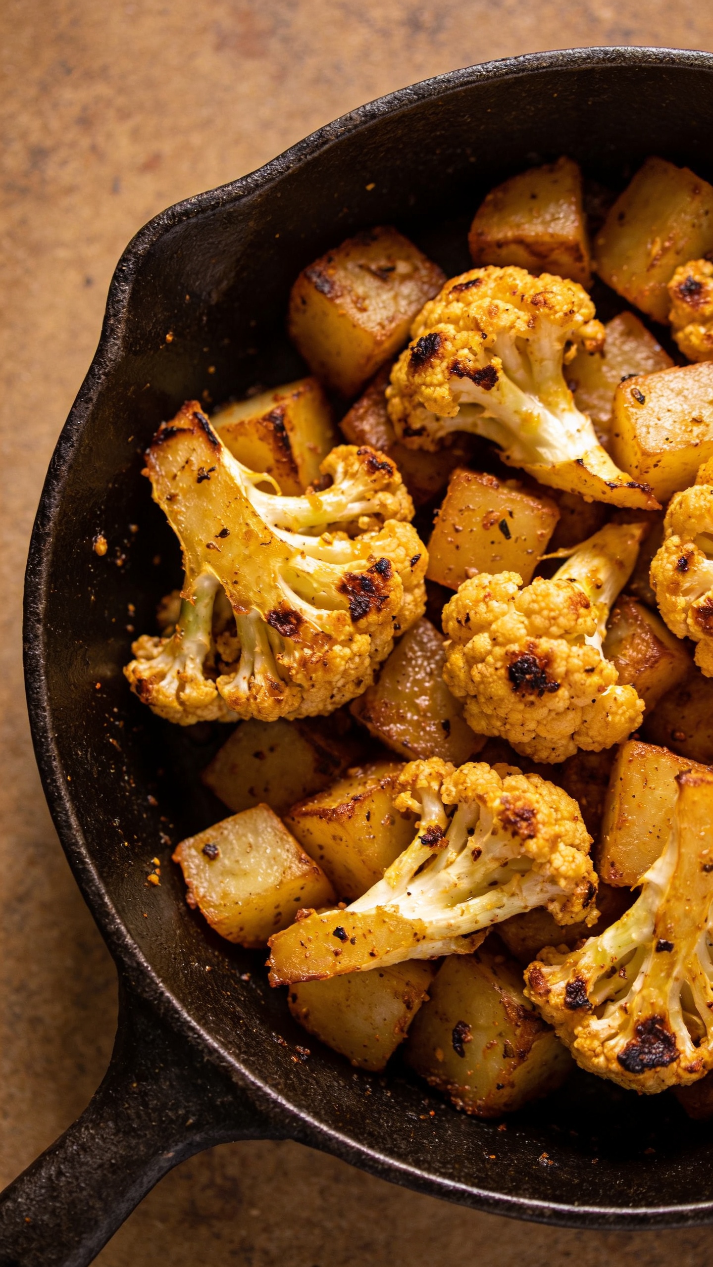 Dry aloo gobi in cast-iron skillet, overhead