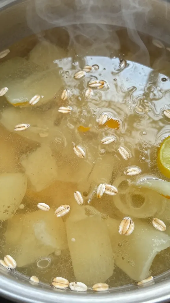 Close-up oats simmering in vegetable broth, umami steam rise